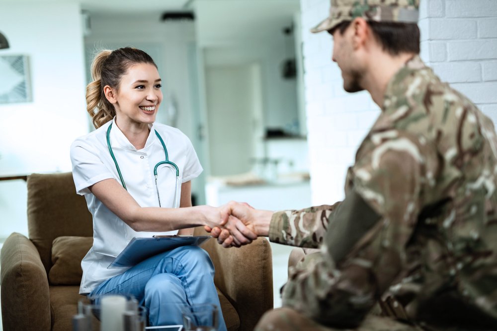 female nurse with veteran shaking hands